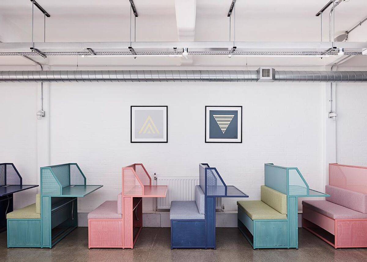 The building, located in the heart of East London’s cultural scene, features white masonry walls and wood block floors and has offices, meeting rooms, event space, a roof garden, and coffee shop.